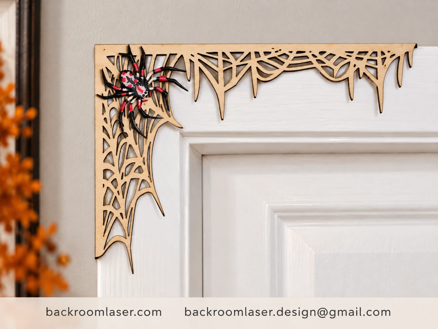 Laser-cut spiderweb accent fitted over a doorway trim corner with a handcrafted 3D resin-domed spider